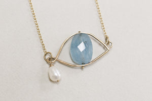 natural blue aquamarine with a soft white freshwater pearl - a signature look of Claire van Holthe's jewellery