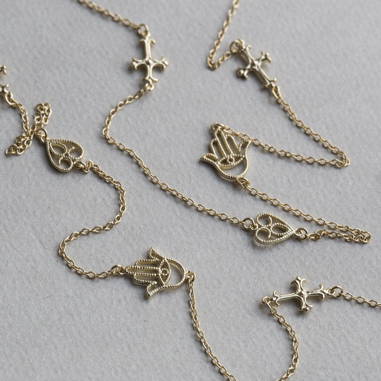 felt gold plated silver heart, cross and hand station necklace