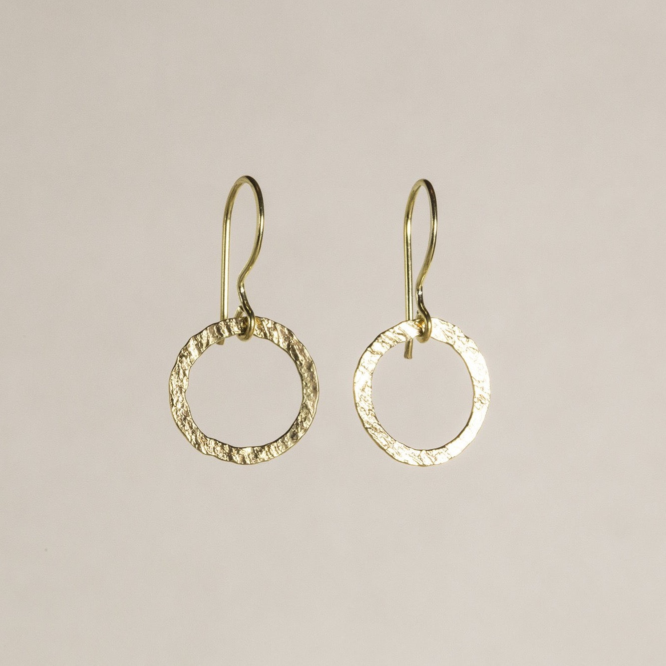 an entwined hoop earrings made of textured gold plated silver