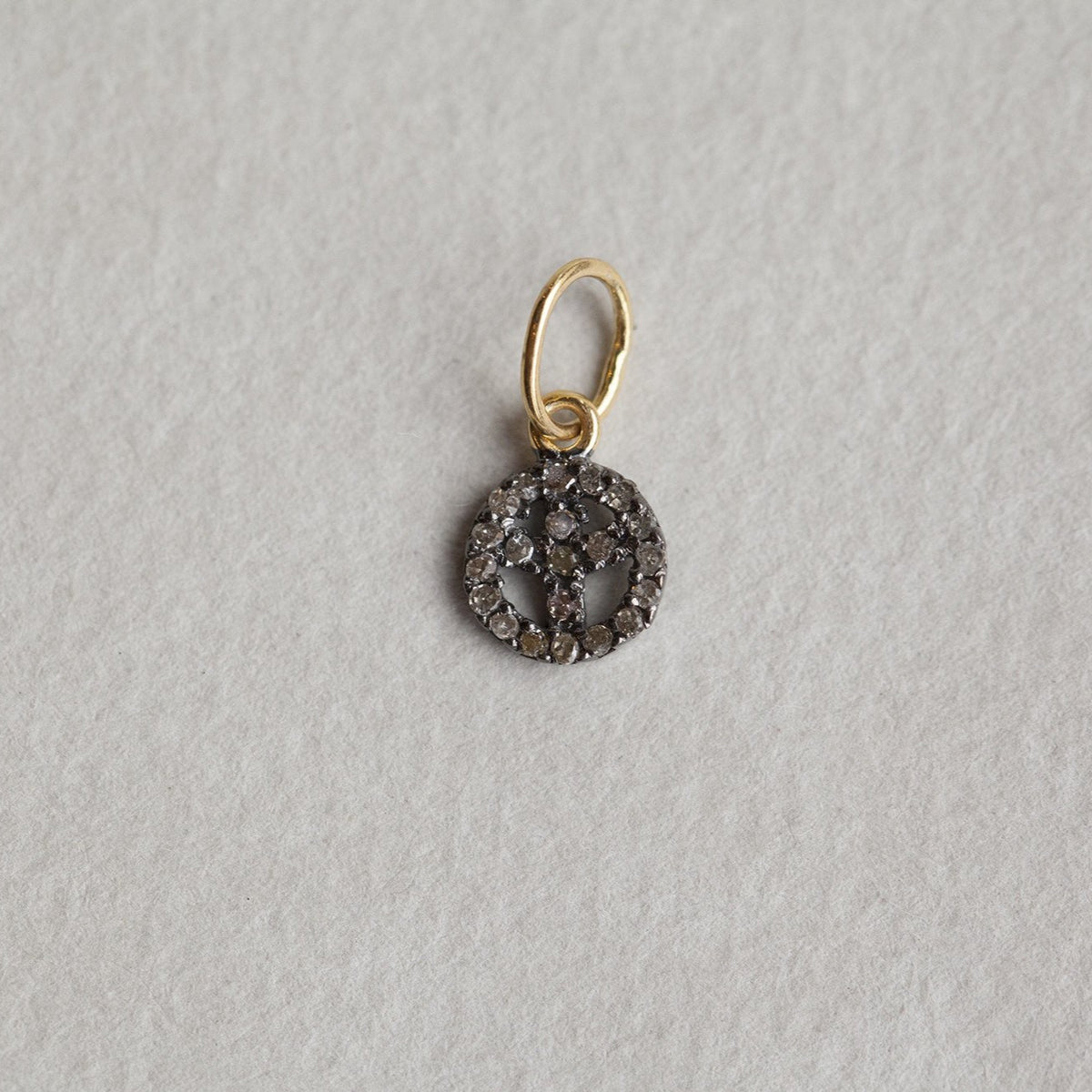 a tiny peace sign from the same collection also available at feltlondon.com