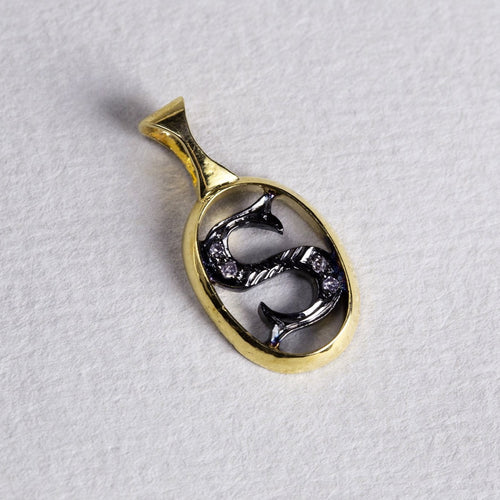 the initial pendants are made of gold, oxidised silver and diamonds 