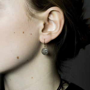 diamond disc earrings on our model