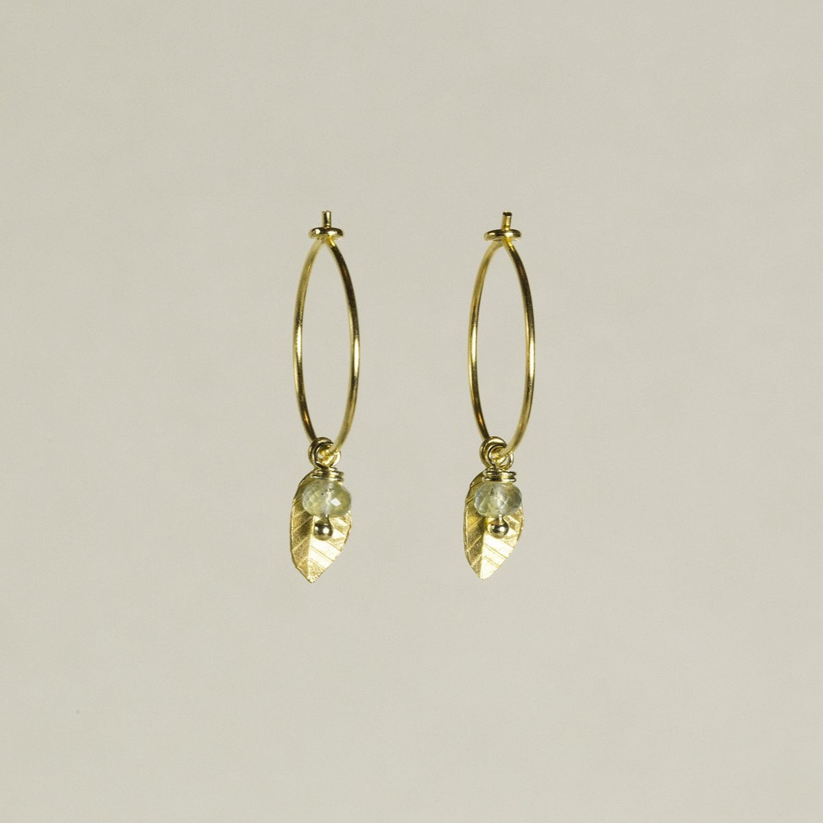 adorable leaf charm hoops with delicately iridescent aquamarine beads, also available at feltlondon.com